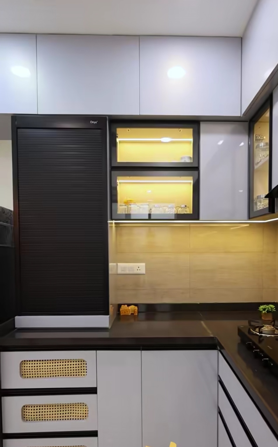 Compact kitchen with roller shutter and accent lighting