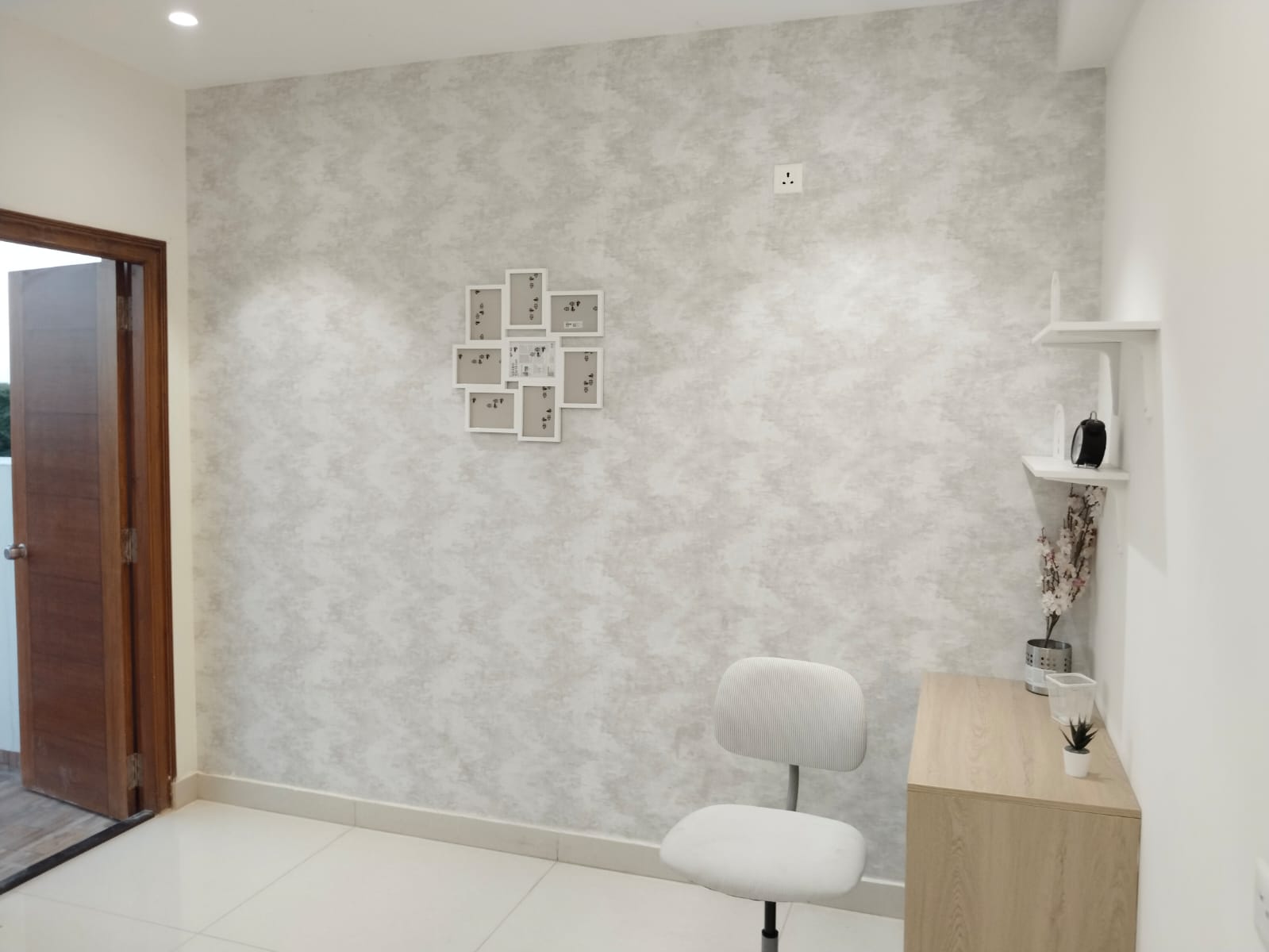 Study nook with textured wallpaper and floating shelves