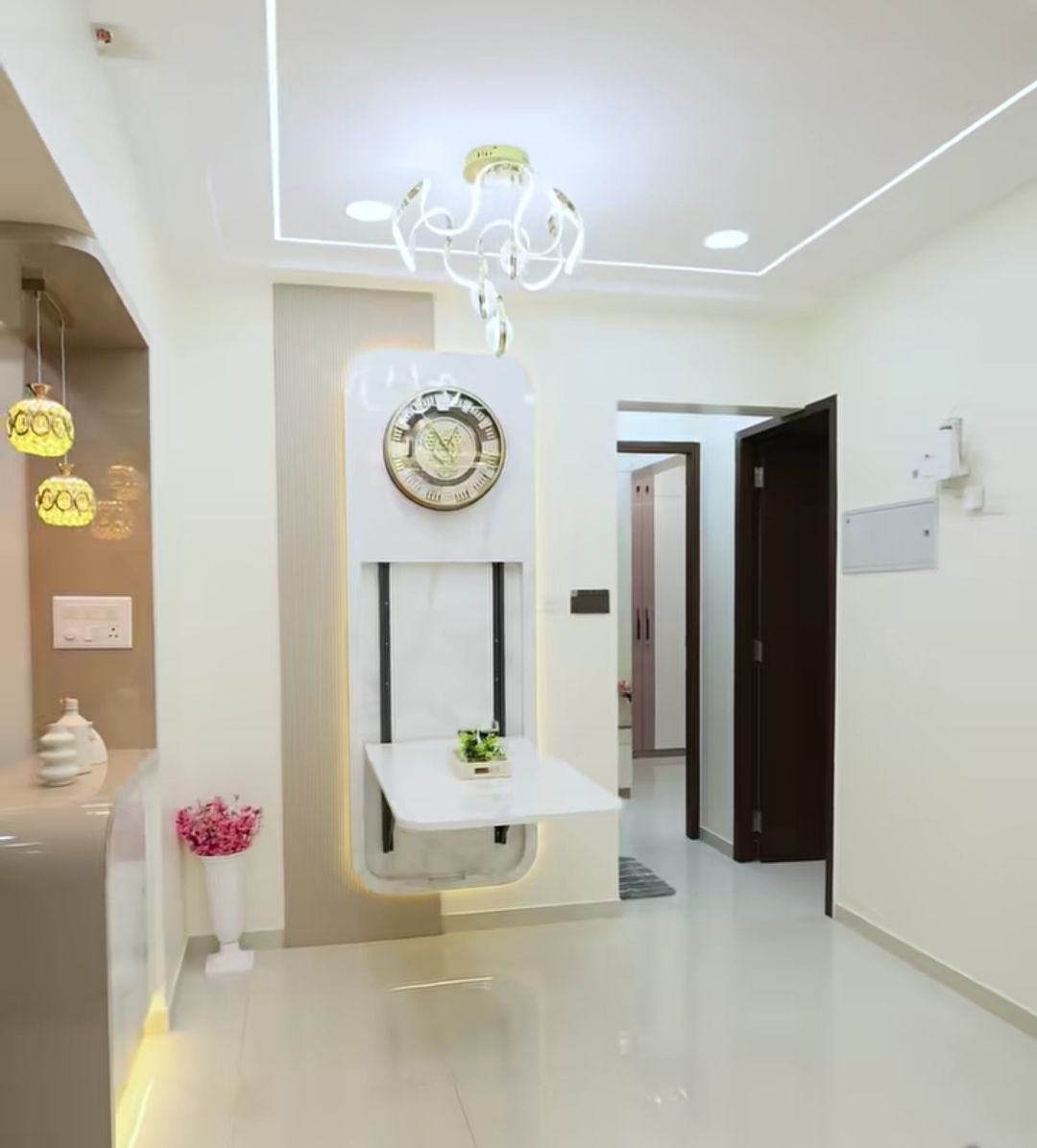 Designer foyer with chandelier and marble accent wall